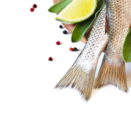 Fresh fish with spices and herbs on a kitchen cutting board close-up with copy space for text.の写真素材
