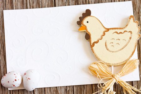 Easter card with funny chicken and small chocolate eggs. Rustic style.の写真素材