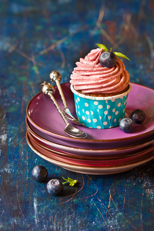 Delicious blueberry cupcake with silver spoon on  plate. の写真素材