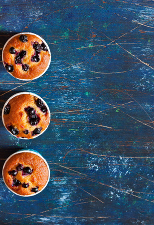 Delicious homemade blueberry muffins on a blue の写真素材