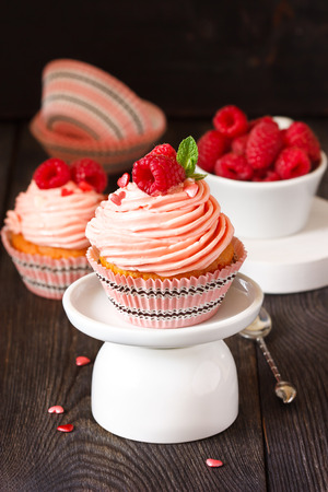 Sweet cupcakes with fresh raspberry and delicious cream.の写真素材