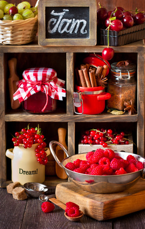 Ingredients for cooking jam. Fresh berries, spices and brown sugar on an old rustic shelves. Vintage style.の写真素材