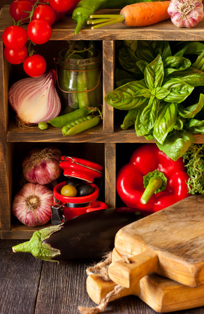 Fresh kitchen garden vegetables on an old wooden shelves. Rustic style.の写真素材