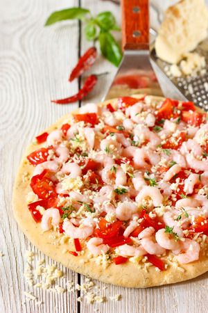Hot shrimp pizza on a pizza maker shovel.の写真素材