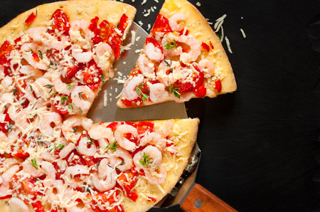 Fresh hot shrimp pizza on a chalk blackboard.の写真素材