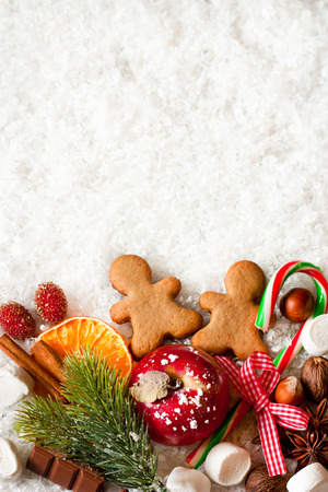 Christmas sweets on snow with copy space for text.の写真素材
