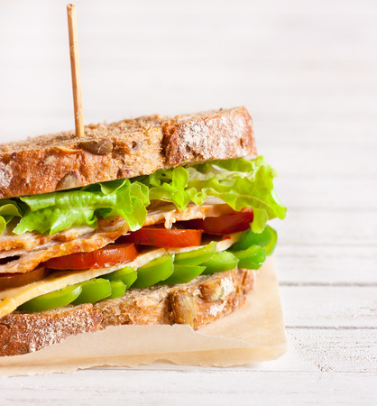 Fresh turkey sandwich with cheese and vegetables.の写真素材