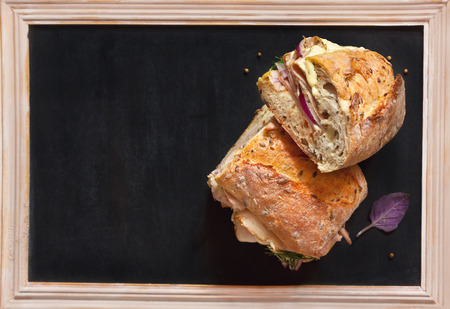 Delicious meat sandwiches and some spices on chalk blackboard with copy space for text.の写真素材