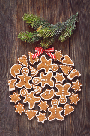 Christmas gingerbread cookie bauble hanging on Christmas tree branch. Toned photo.の写真素材