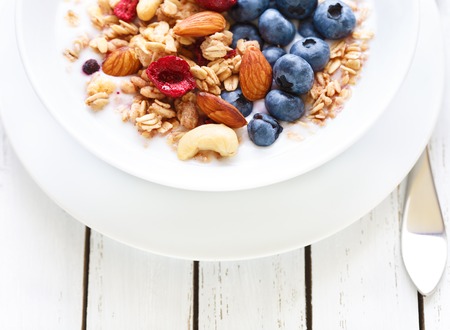 Homemade granola with fruit nuts and fresh yogurt.の写真素材