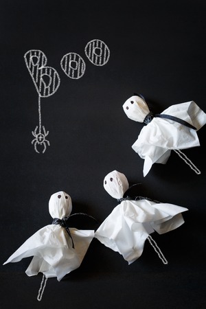 Halloween ghost lolly pops on black chalkboard.の写真素材