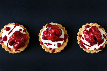 Fresh halloween bloody brain biscuits on dark background.の写真素材