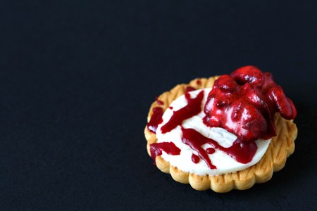 Fresh halloween bloody brain biscuits on dark background with place for text.の写真素材