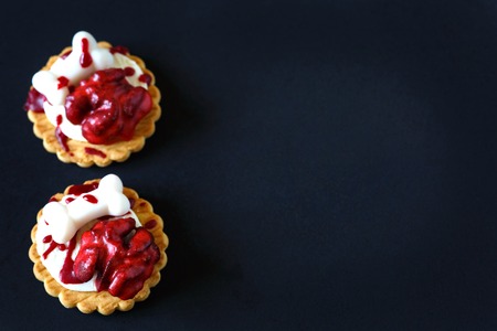 Fresh halloween bloody brain biscuits on dark background with place for text.の写真素材