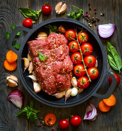 Raw stuffed meat and vegetables on pan before roasting.の写真素材
