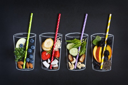 Chalk painted glass with fresh food ingredients for blending smoothie on chalkboard.の写真素材