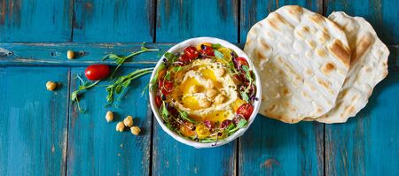 Hummus with olive oil, sprouts and tomatoesの写真素材