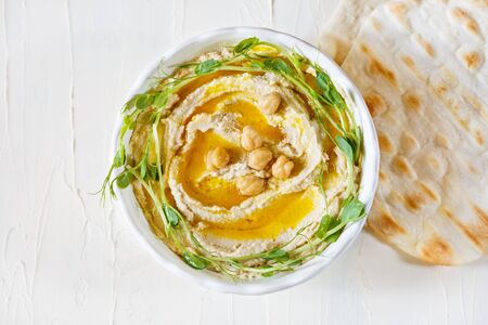 Hummus with olive oil and sprouts