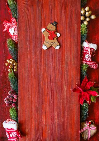 Decorative wooden gingerbread man on vintage red  with copy space for greeting, menu or your text.の写真素材