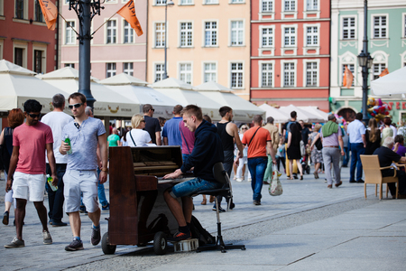 Wroclaw Poland - May 20, 2018: A young guy playing the piano on the square at the Town Hall of...