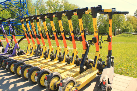 Moscow, Russia - May 26, 2022. View of Yandex Go yellow electric kick bike scooters parking for rent...