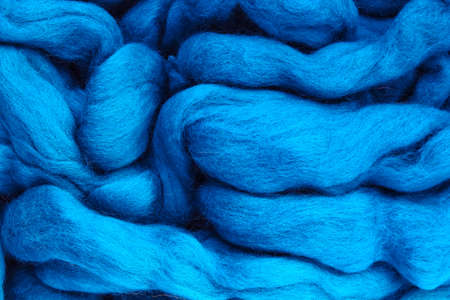 Close-up of colourful merino wool deep blue striped background. Abstract handmade craft knitting yarn textured pattern flatlay. Holiday christmas concept. Idea for felting, needleの写真素材