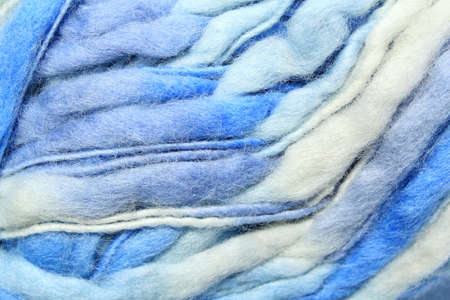Close-up of colourful merino wool white and blue striped background. Abstract handmade craft knitting yarn texture pattern flatlay. Holiday winter concept. Idea for felting, needleの写真素材