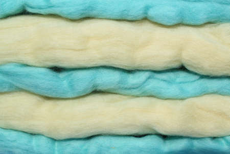 Close-up of colourful blue and beige merino wool striped background. Abstract handmade craft...