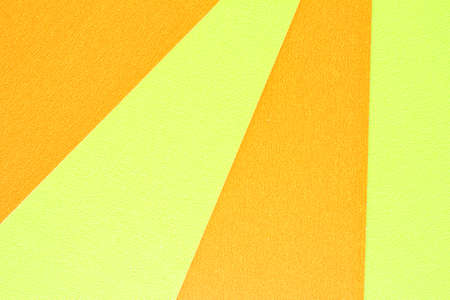 Abstract creative texture geometric pattern craft paper background. Yellow and orange colors. Structure design cardboard poster shape backdrop. Top view with copy space for text, fの写真素材