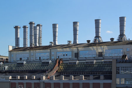 Pipes of thermal power plant on a town. Industrial zone in the city. Producing electrical energy...