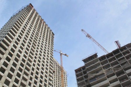 Crane and building construction site. Industry modern new civil house business. Concept of...