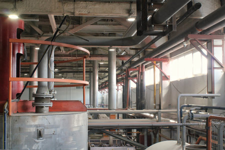 Interior of a modern beer factory, detail of pipes and equipment