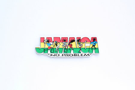Colorful PVC souvenir fridge magnet of Jamaica on white background. Travel memory concept. Gift product for tourists from foreign trip. Top view, flat lay, close upの写真素材