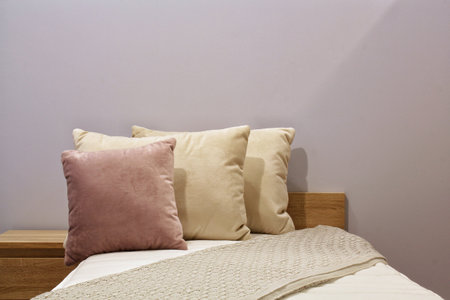 Close-up of comfortable colorful soft pillows on bed. Stylish trendy apartment home decor. Hygge scandinavian loft design. Interior of modern bedroom in hotel. Comfort sleep and reの写真素材
