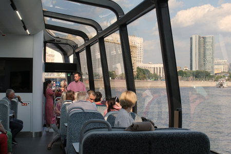 Passengers on a board of aquabus boat on Moskva River. electrical ship. Ecological public transport. Green energy in city route. Daily passenger ferry service. Moscow, Russia - Juのeditorial素材