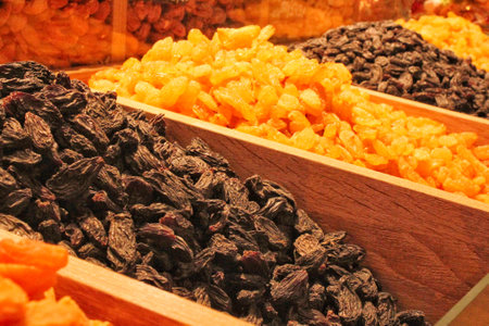 Close up of assorted dried fruits in wooden boxes on Turkish bazaar. Healthy vegetarian food. Dry fruits at Grand bazar. Apricots, raisins in local city market. Symbols of Jews hの写真素材