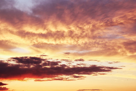 Twilight sunset sky. Nature background. Soft golden clouds. Sunrise early morning. Dramatic pastel...