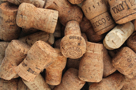 Pile of natural wooden wine corks close up as background. Concept of environmental protection and waste separation. Recycled closures used for sealing wine bottles. Moscow, Russiaのeditorial素材