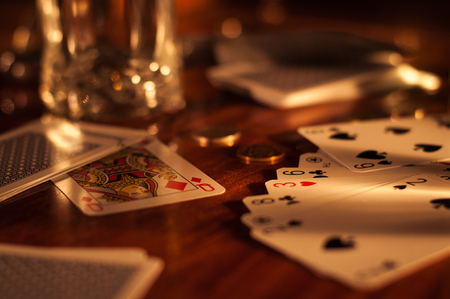 Cards, money and glass on wooden table.jpgの写真素材