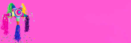 Pink banner with pinata and sweets coming out of it. High quality photoの写真素材