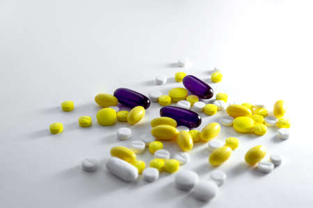 Dramatic illumination of pills and aspirin on a white background. High quality photoの写真素材
