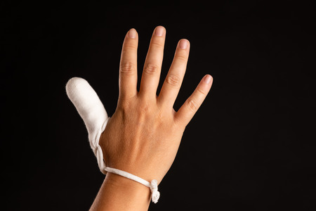 injured thumb with bandageの写真素材
