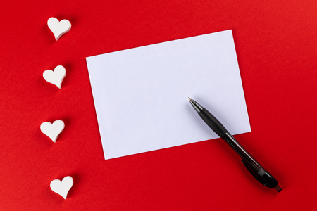 top view with red background with hearts for writing a love letter for valentines day and copy spaceの写真素材