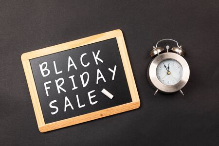 black friday sale with clock at a black backgroundの写真素材