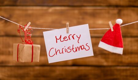 Nicholas hat, present and a note with copy space hang on a ropeの写真素材