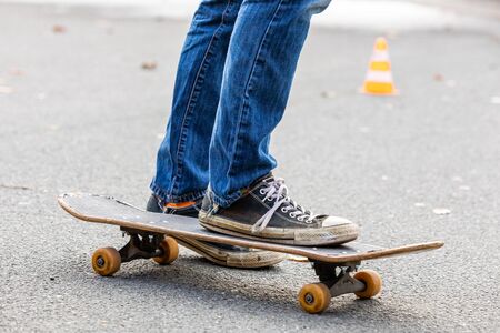person is riding on the skateboard in autumnの写真素材