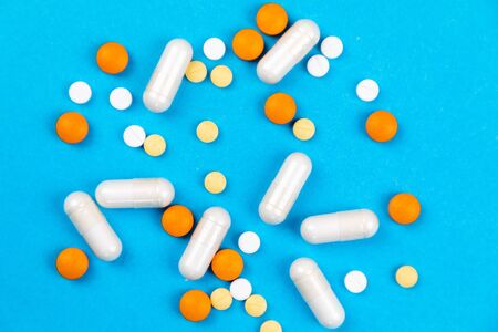 Tablets medicaments on a blue background with copy space