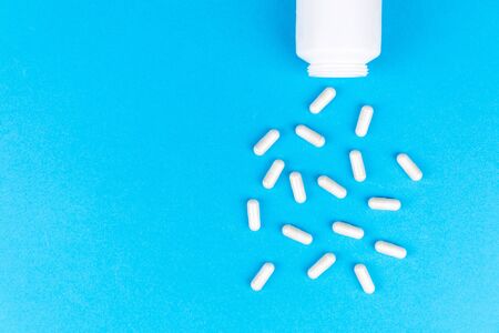 Tablets medicaments on a blue background with copy space