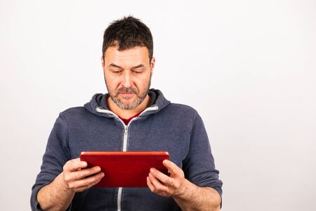 young man uses a tablet with white backgroundの写真素材