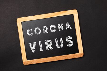 chalkboard with text coronavirus on a black backgroundの写真素材